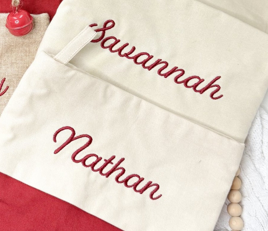 Script name embroidery detail on Christmas stockings